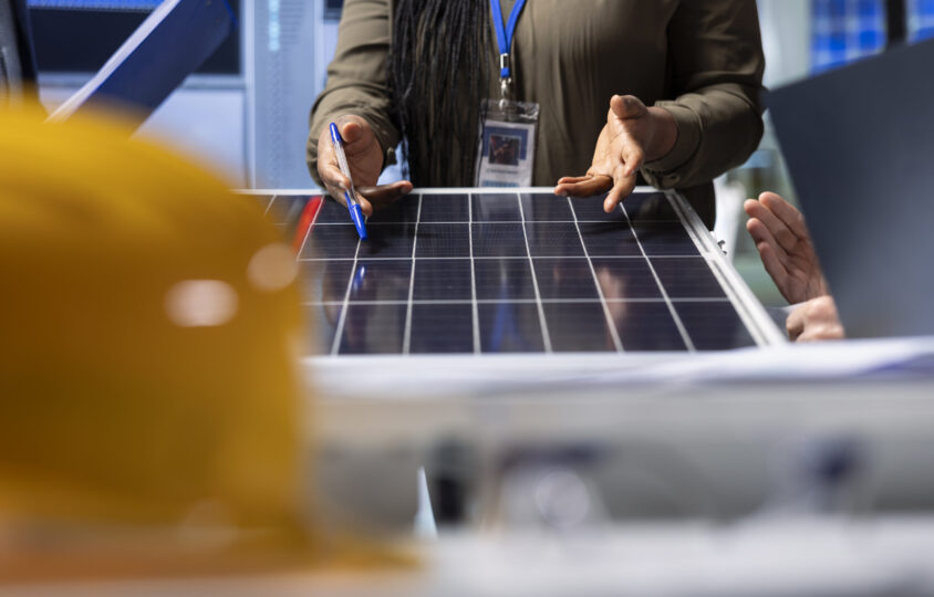 shareholders reviewing solar panel components analyzing material quality
